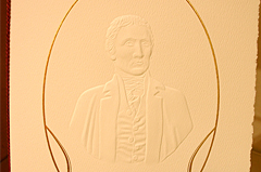 Upscale, commemorative piece for the unveiling of a marble bust of Meriweather Lewis at the Capitol Building using, multi-level blind emboss, with metallic printing on parchment paper with and formal tassle - Imagery encircling blind emboss was another emboss printed with gold foil process
